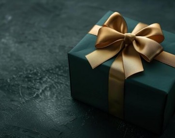 Dark green gift box with elegant gold ribbon photo